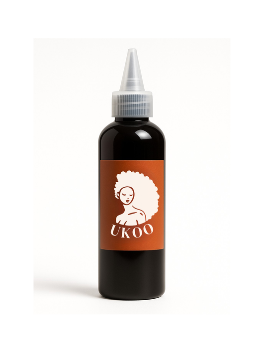 Black Ukoo hair oil bottle with a brown label featuring the UKOO logo on a white background